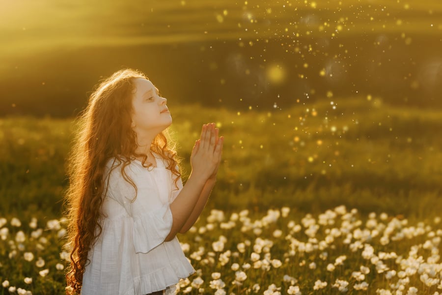 Little girl with praying. Peace, hope, dreams concept.